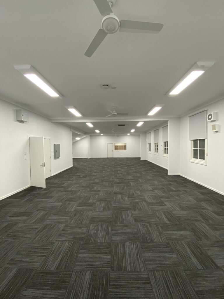 Spacious, well-lit interior with ceiling fans.
